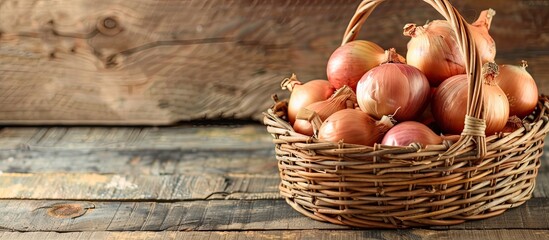 Leinwandbilder - A wicker basket on a wooden table filled with ripe onions with copy space image