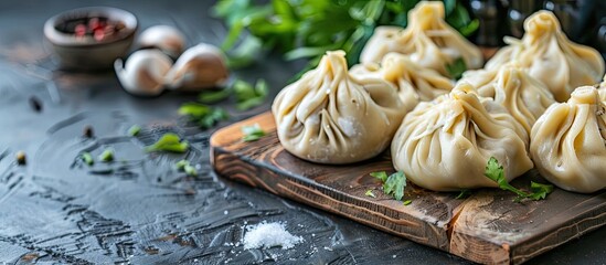 Poster - A popular Georgian dish meat khinkali is displayed uncooked on a cutting board with ample copy space image
