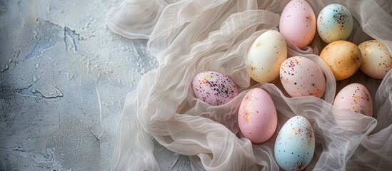 Poster - Easter eggs arranged on textured fabric backdrop creating a lovely Easter decor setting with copy space image