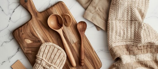 Wooden kitchen utensils cutting board potholder and glove along with kitchen mitten and oven mitts displayed on a table with a top view featuring kitchenware accessories and a close up with copy space