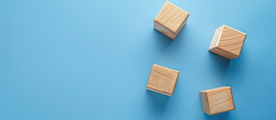 Sticker - A bird s eye view of three empty wooden cubes on a blue backdrop with copy space image