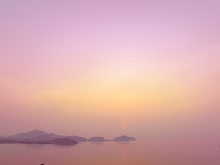 Wall Mural - Aerial view stunning the golden sun shining above the island..Scene of colorful reflection on the sea surfect. sweet sky cover the ocean..Gradient color. Sky texture, abstract nature background..