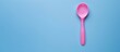 © vxnaghiyev - A plastic spoon intended for feeding babies is placed alone with ample copy space image
