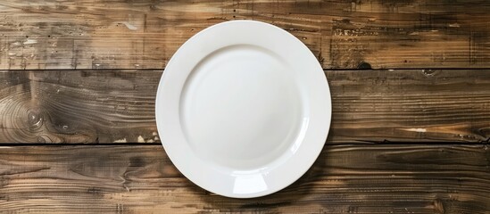 Aufkleber - White plate on a wooden surface with copy space image