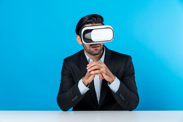 Professional businessman wearing visual reality glasses and suit while sitting. Smart caucasian project manager looking at data analysis by using VR headset. Innovation technology concept. Deviation.