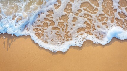 Poster - Soft wave with foam on sandy beach background with space for copy