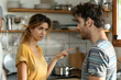© Aodsy - A couple arguing in the kitchen, with the woman pointing and looking upset while the man listens intently.