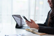 © crizzystudio - Asian businesswoman using a smartphone at her desk. Typing, chatting, texting, SMS, mobile applications, online shopping, talking. Contact online with co-workers Business customers in the office.