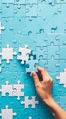 Aufkleber - Hand placing final piece into blue puzzle. Concept of completion, solution, and achievement.
