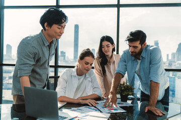 Skilled multicultural businesspeople discuss about business idea. Professional manager brainstorming, sharing, planing marketing strategy. Business team working together at modern office. Tracery.