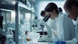 © TheosArtTavern - A woman is looking through a microscope in a lab