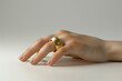 © Iqra - Hand with gold ring on white background, 3D illustration