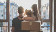© Oleksiy - Happy family with children moving with boxes in a new apartment house. Back view