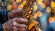 © uros - A close-up of a senior retired elderly man's hands playing a golden saxophone, a musical instrument. Concert performance, classic jazz acoustic song, trumpet orchestra on a stage, vintage sound