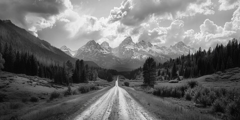 Poster - A classic image of a dirt road winding through the mountains, shot in black and white