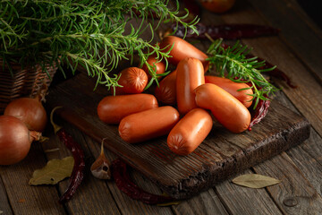 Wall Mural - Sausages with rosemary, onion, garlic, red pepper, and bay leaves.