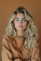 Natural Portrait of a Woman With Wavy Hair Against a Brown Background