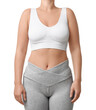 © New Africa - Woman wearing sports bra and leggings on white background, closeup