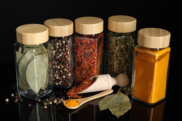 Wall Mural - Different spices in glass jars on black mirror surface