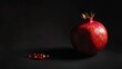 © Lull - Red pomegranate fruit on dark background. A vibrant, whole pomegranate sits on a dark backdrop, with a scattering of its juicy arils nearby, emphasizing freshness and flavor.