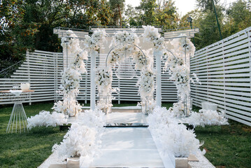 Wall Mural - Outdoor wedding photo zone decorated with flowers.