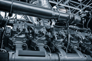 Poster - Large industrial diesel engine or diesel generator close-up with many pipes and other parts. Industrial concept background
