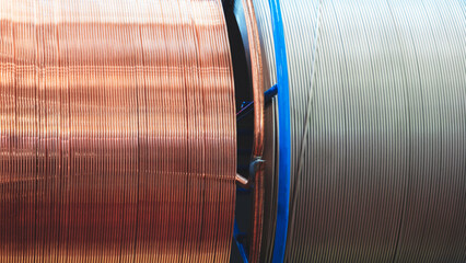 Poster - Two long metal wires for welding metals, one of which is steel and the other is copper. The wires are wound on large spools. Industrial concept metalworking texture background or template, web banner