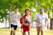 © famveldman - Family playing American football. Kids play rugby