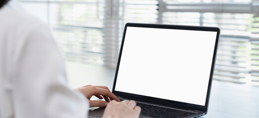 woman hand using laptop and type on the keyboard, mockup screen of advertisement.