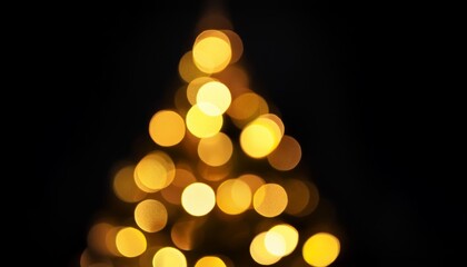 Wall Mural - bokeh yellow lights of christmas tree on black background