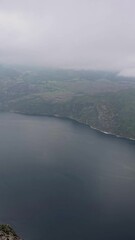 Wall Mural - A breathtaking aerial video of a lake from a mountain top, featuring a cliff overlooking the tranquil water, showcasing the beauty of nature at its finest, Preikestolen Norway