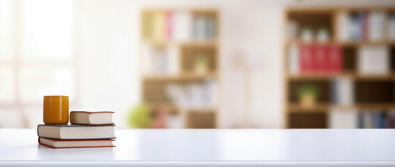 Aufkleber - Stack of books and a cup of coffee on a table in a home office, with a bookshelf in the background