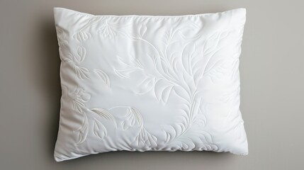 Wall Mural - Elegant white pillow with ornate embroidery, set against a seamless background, providing ample space for copy text