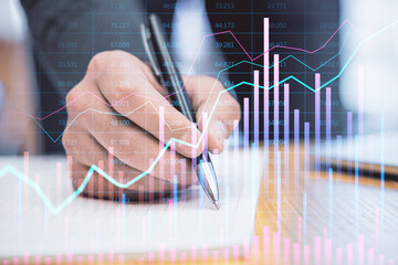 Poster - Financial analyst writing on a document with stock market graphs overlayed.