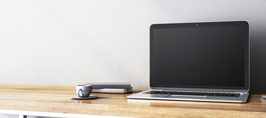 Poster - Blank laptop screen on wooden desk with books and cup. 3D Rendering