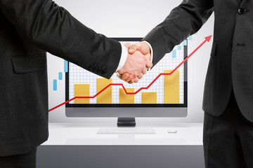 Poster - Two businessmen shaking hands in front of a computer displaying upward growth chart.