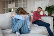 © DimaBerlin - Woman in tears, sadness, hides face and shrinks on couch, while her distressed husband sits at other end. Family toxic bonds, disputes and mutual disregard in relationship lead to divorce