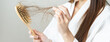 © KMPZZZ - Stress asian young woman, girl hand holding comb show her hairbrush with loss, hair in brush after brushing, hair fall out problem. Health care, beauty with treatment concept, isolated on background.
