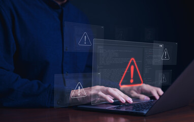 Wall Mural - Cybersecurity alert concept. Person using laptop with multiple warning symbols displayed, indicating cyber security alert. importance of digital security and data protection, Cybercrime and virus,