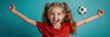 © RISHAD - Excited young girl in a red shirt, with arms raised and mouth open in joy, standing in front of a blue background with a soccer ball in mid-air behind her.