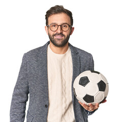 Hispanic male soccer coach with ball in studio