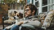 © Emilio - Owner with his jack rassel terrier sitting on terrace at home. Little dog and male dog sitter spending time together outdoor. House sitting and pet care service. Man and puppy cozy warm portrait