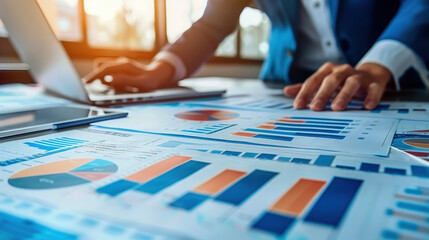 Poster - Business professional analyzing charts and graphs on a desk, showcasing financial data and strategy development.