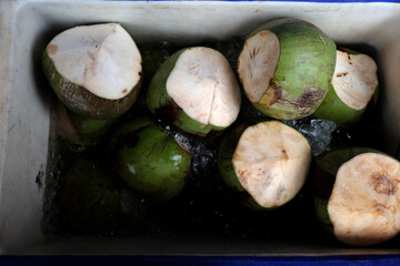 green coconuts in the refrigerator with ice