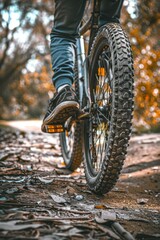 Wall Mural - a person riding a bike on a dirt path