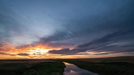 Wall Mural - beautiful colorful sunset over the river, red and yellow flashes. ripples on water surface of sea or