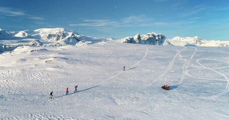 people enjoy outdoor sport activity in antarctica. group of scientists from polar station run snow t