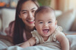 © Centric  - Smiling Asian mother and her happy baby enjoying a moment together, capturing love and joy in a home setting
