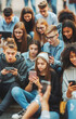 © Christoph Burgstedt - Group of young people who are preoccupied with their smart phones, which are an important part of culture and can lead to addiction