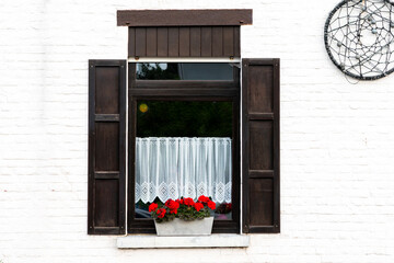 Sticker - Window with wooden shutters and flowers on the windowsill, window decor, wall with beautiful windows, house with shutters,Wooden window village cottage house.